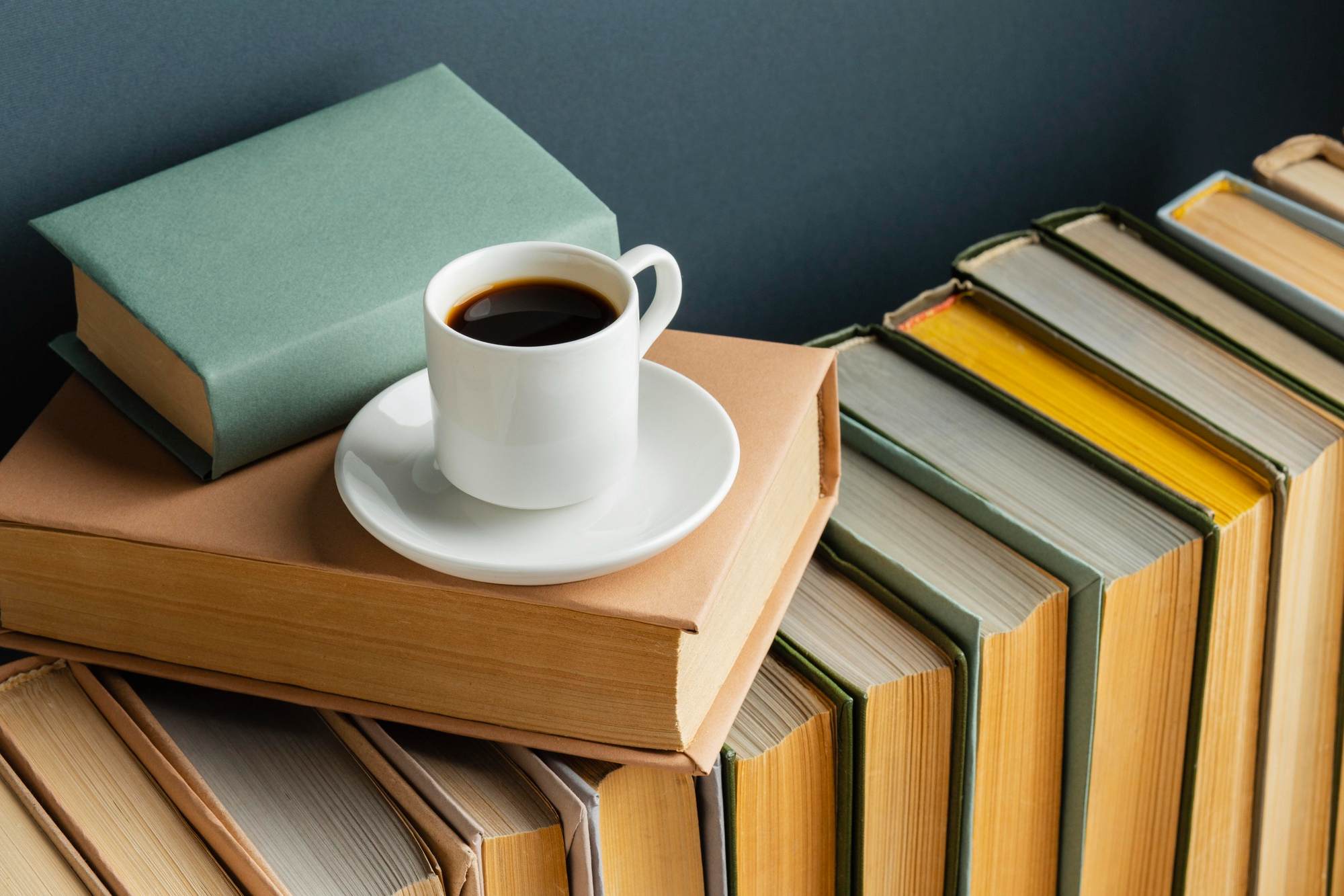 Books with coffee sitting on top